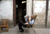 Shanghai, China: Qibao town - man reading the newspaper - photo by Y.Xu