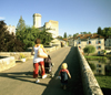 Bourdeilles, Dordogne, Aquitaine, France: toddler and woman with stroller cross the bridge towards Chteau de Bourdeilles - photo by K.Gapys