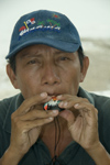 Panama - Panama City: man blowing trinket whistle in the old town - photo by D.Smith