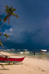 Alona Beach, Bohol island, Central Visayas, Philippines: local bancas on a white sand beach with storm clouds - photo by S.Egeberg