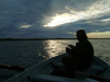 South Uist island / Uibhist a Deas, Outer Hebrides, Scotland: fisherman in the evening on Loch Bornish - angler on a boat - photo by T.Trenchard