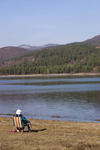 Slovenia - Pivka Valley: woman sitting on deck chair beside Petelinjsko jezero, Pivka intermittent lakes - photo by I.Middleton