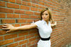 young Oriental woman in a glamorous fashion pose against a brick wall. Model is Malibu Stacy of Vancouver, BC, Canada. Photographed at False Creek, Vancouver, BC, Canada. Model and property released - photo by D.Smith