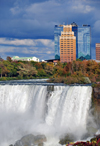 Niagara Falls, New York, USA: cascading waters of Bridal Veil Falls, Luna Island and hotels in the background - aka Iris Falls - photo by M.Torres